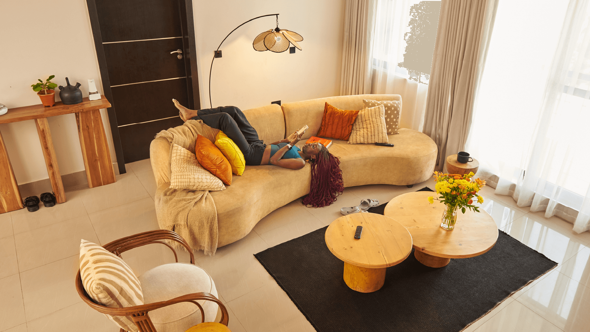 Customer relaxing on a curved sofa in a clean living room